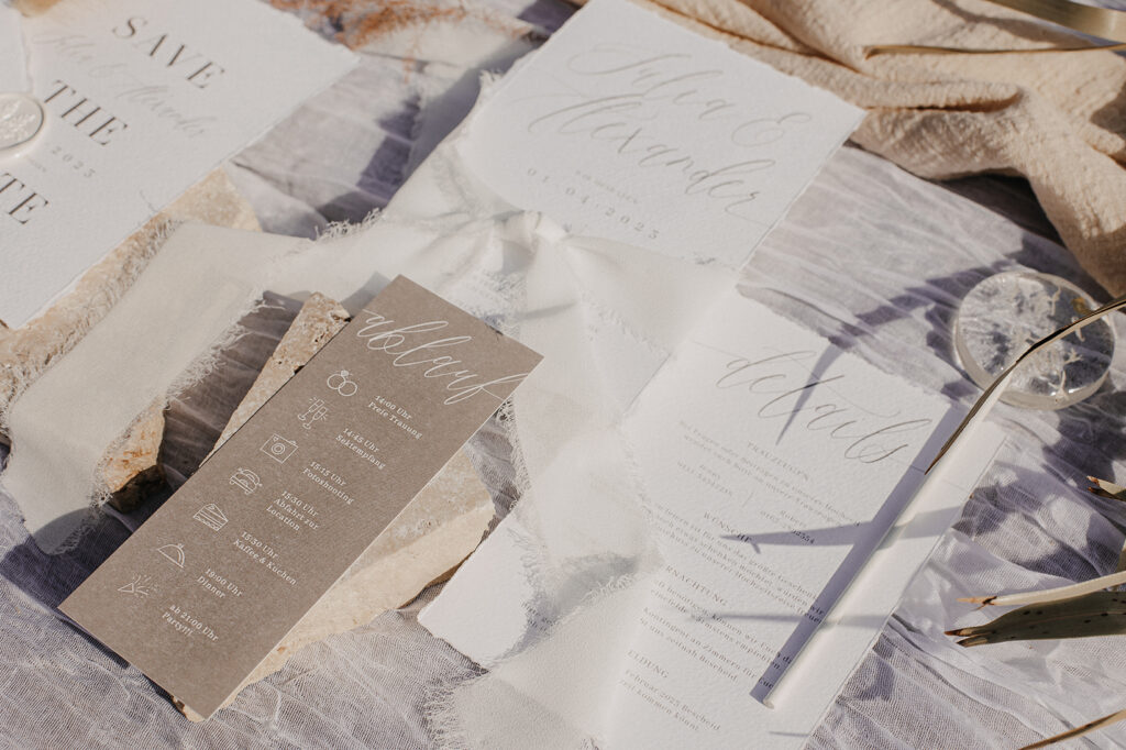 Hochzeitspapeterie auf Büttenpapier mit gerissenen Kanten und Chiffonband